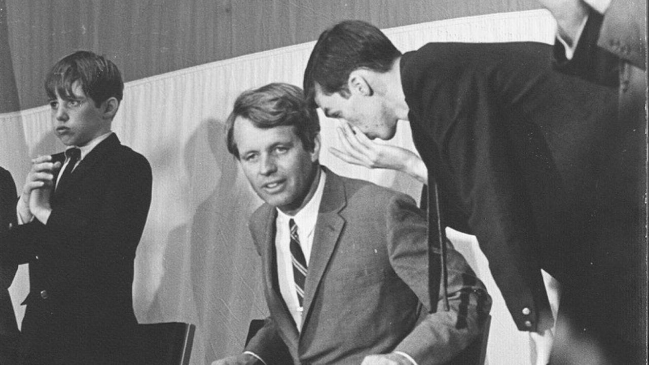 Frye Gaillard whispers to Robert F. Kennedy during the Impact Symposium, which Gaillard chaired in 1968.